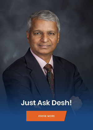 Indian Man in black suit and tie crossed arms